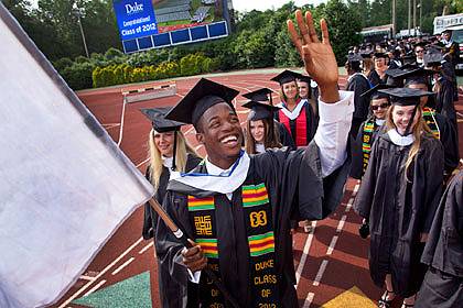 Toby Ubu, senior class president, leads graduates into Wallace Wade Stadium at the beginning of the commencement ceremony. Photo by Les Todd/Duke University Photography