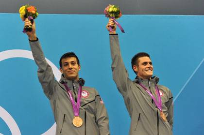NIck McCrory, left, and David Boudia celebrate on the medal platform Monday.  Photo by Christophe Simon/AFP/Getty Images