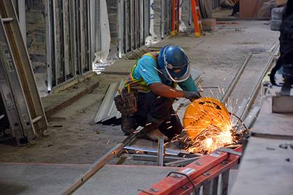 Sparks fly as a construction worker cuts through metal poles inside the West Union. The renovated space is set to open two portions of the building in February. Photo by Bryan Roth.