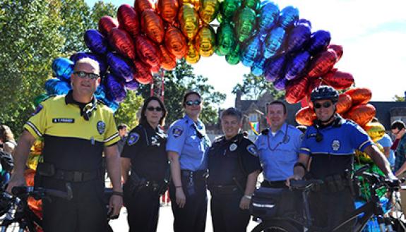 Duke Police staff pose in front of a rainbow arch created for 2014's Coming Out Day. Students and employees are invited to join the annual celebration, which returns Oct. 8. Photo by April Dudash.